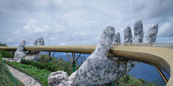 To store stenhænder der holder en bro.